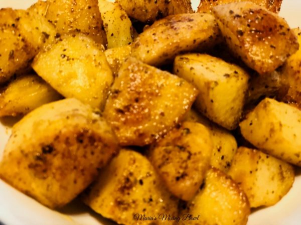 close up of ranch potatoes on table  in a bowl 
