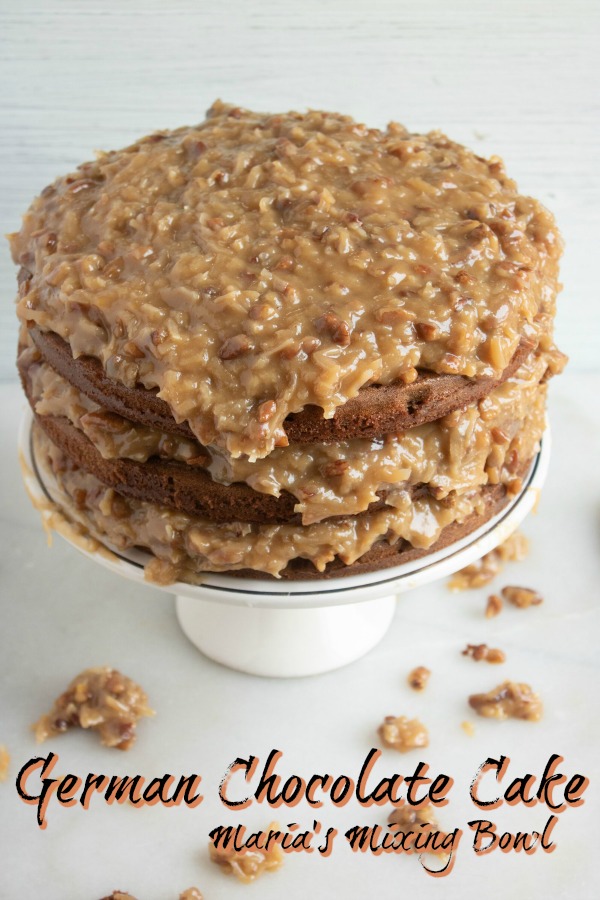 German Chocolate Cake that is 3 layers is sitting on a platter 