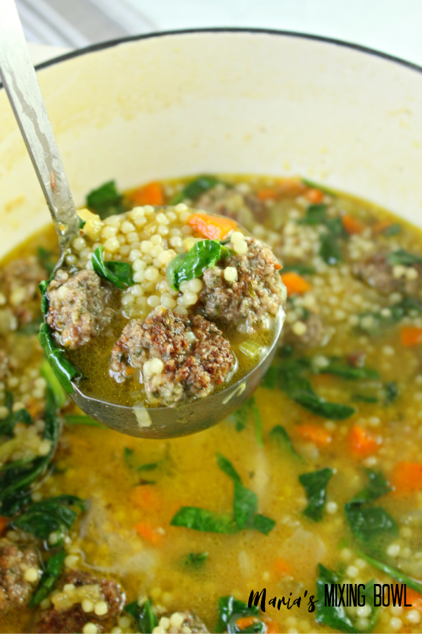 a ladle of wedding soup in a soup pot