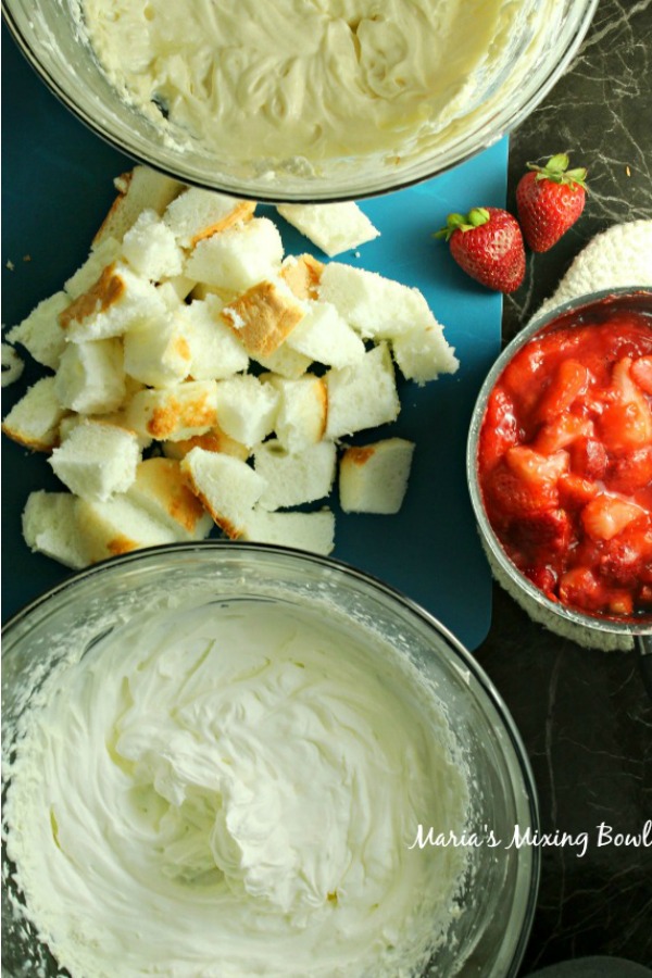 All the ingredients for this strawberry dessert in bowls sitting on table