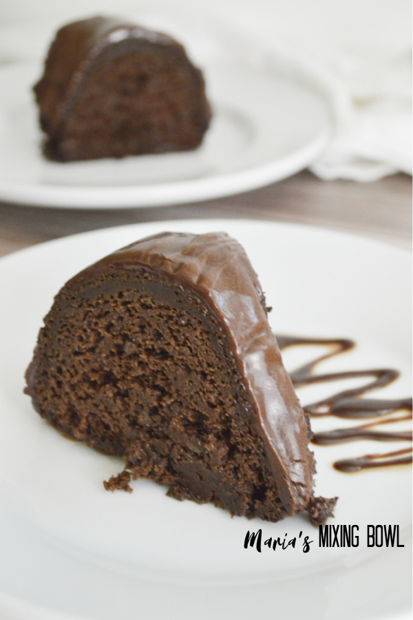 Fudgy Chocolate Pumpkin Bundt Cake slice with fudge sauce on the side