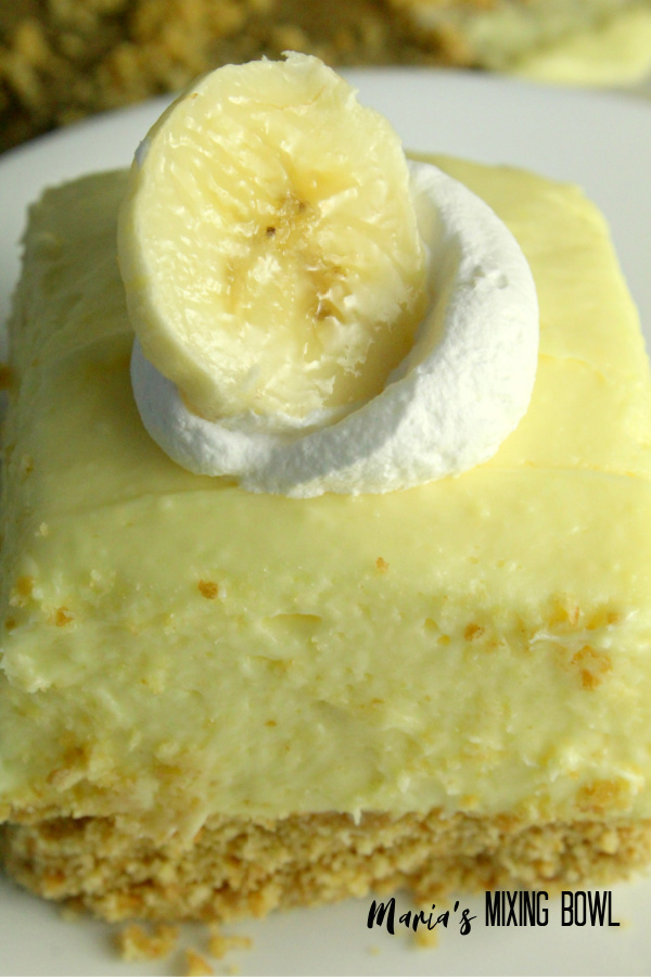 Banana Cream Cheesecake Bars slice on a white plate