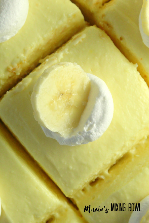 Banana Cream Cheesecake Bars with whipped Cream and Banana