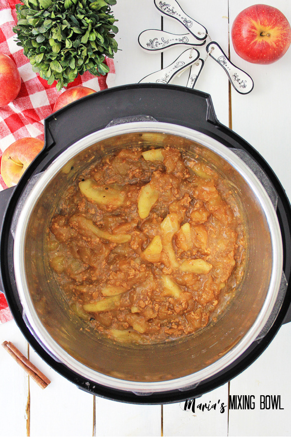 apples after cooking in the instant pot red and white checked napkin and apple around instant pot