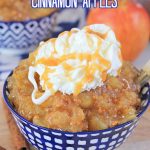 cinnamon apples in a blue and white bowl topped with whipped cream with apples