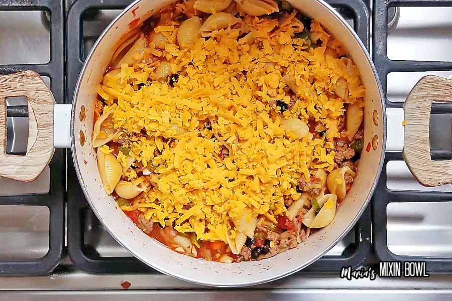taco pasta with cheese in a pot on stove top.