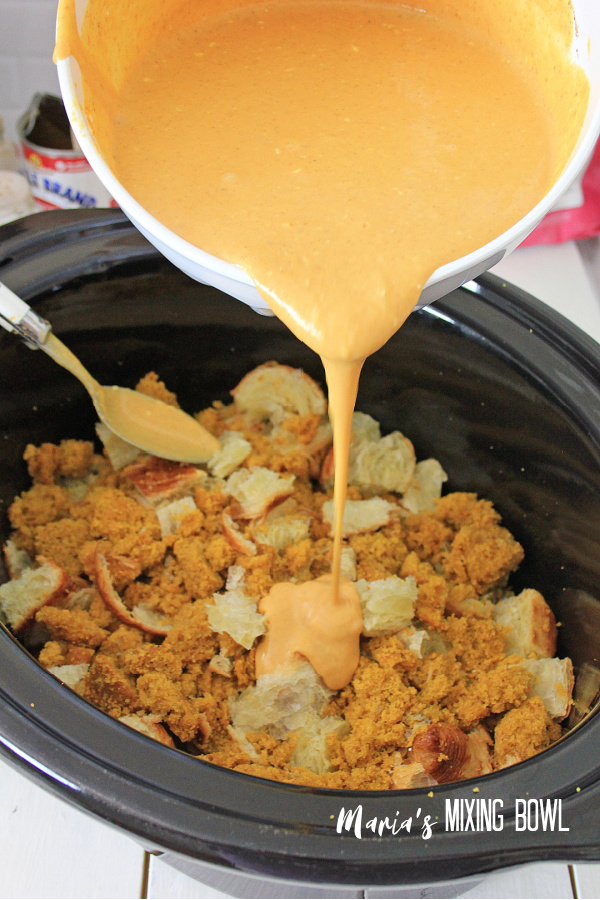chopped pumpkin muffins and crossants in a crockpot pumpkin mixture poured over top