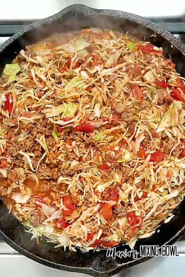 cabbage cooking in an iron skillet