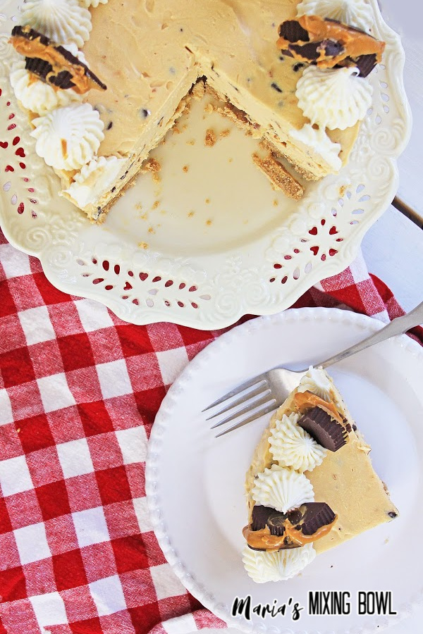 white and red check napkin with cake plate and cake on top a slice is taken from it and in a white dessert dish