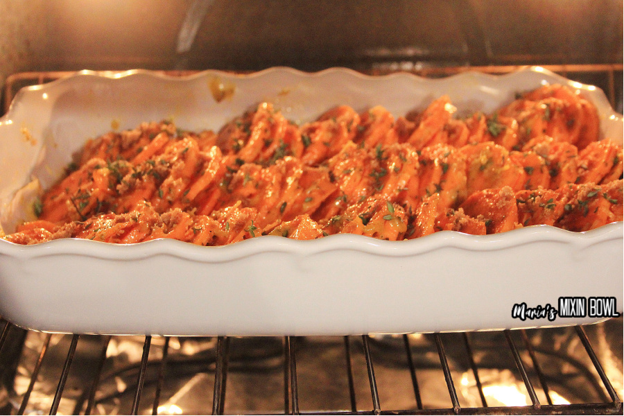 sweet potatoes in a white baking dish in the oven baking 