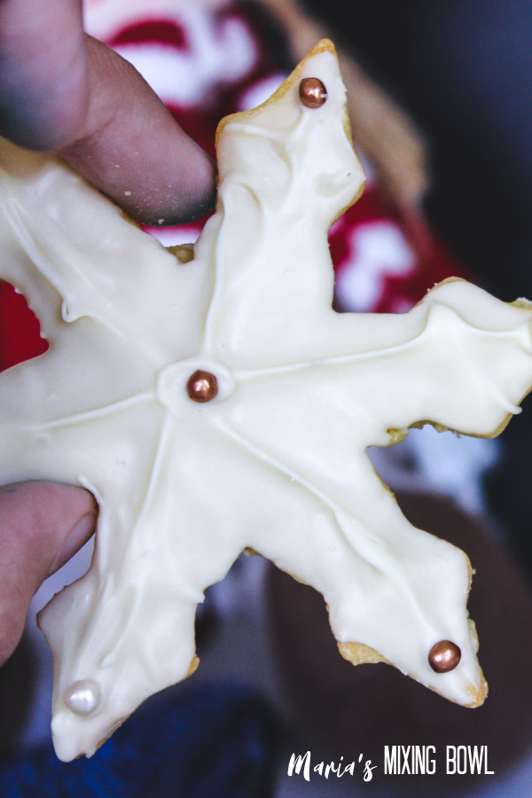 star shaped cookie decorated with white chocolate and beads