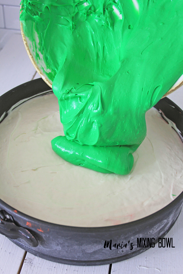 green cream cheese layer pored on top of white layer