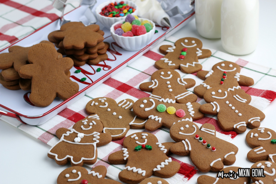 Gingerbread Cookies being decorated on a white and red check napkin