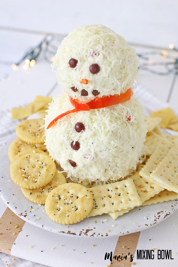 snowman appetizer on a white plate with cracker