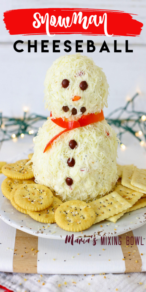cheeseball with crackers on a white plate white lights in background
