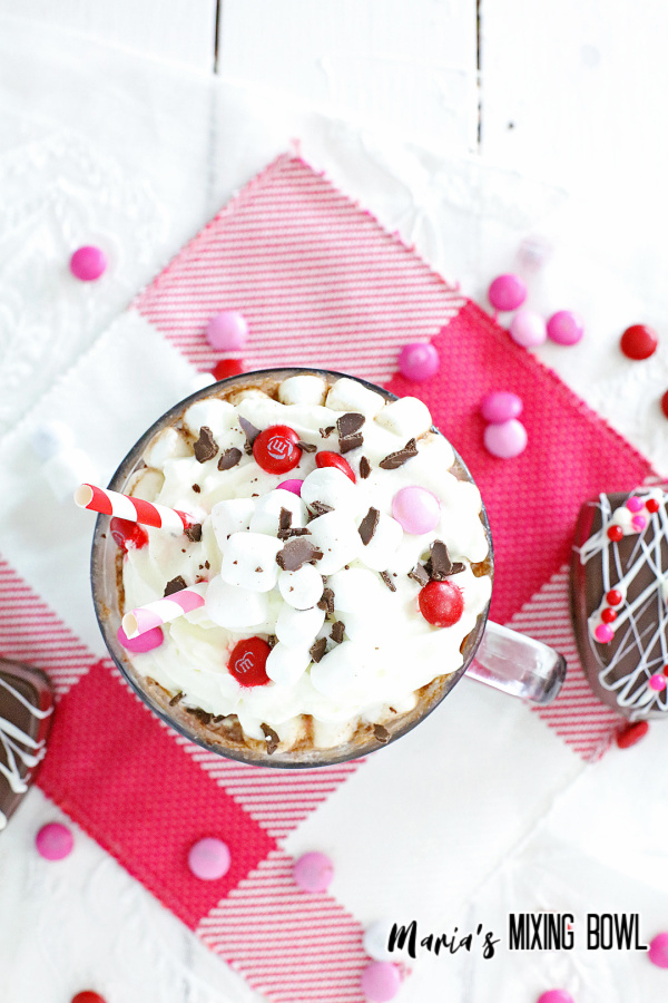 chocolate bomb in a cup with milk pink and white napkin