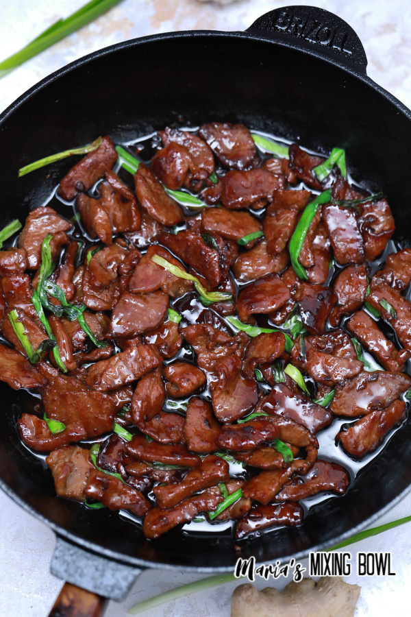 Mongolian beef cooking in a skillet