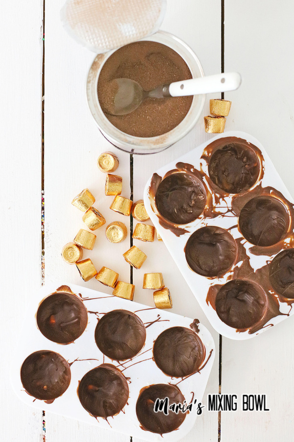 Overhead shot of caramel hot cocoa bombs ingredients on white table