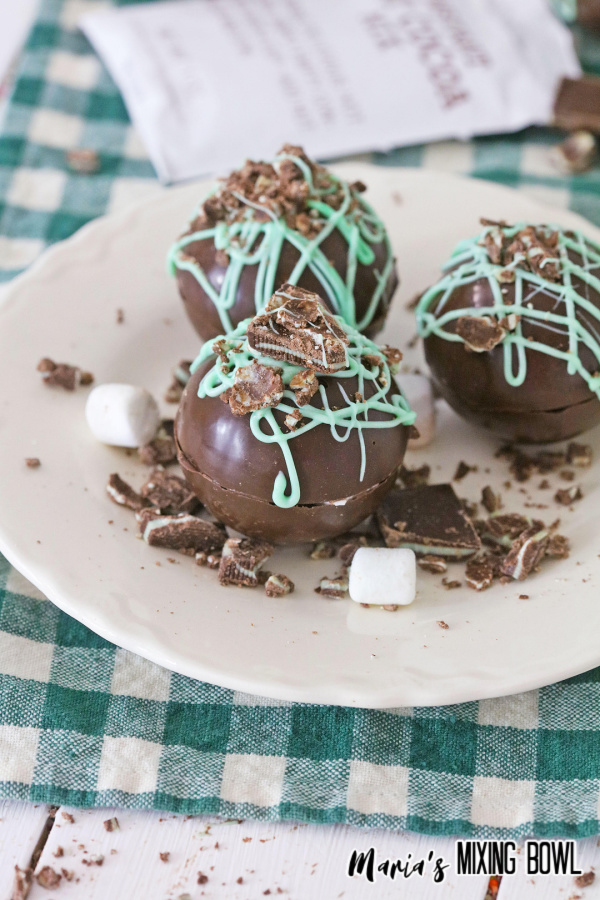 mint hot cocoa bombs on white plate