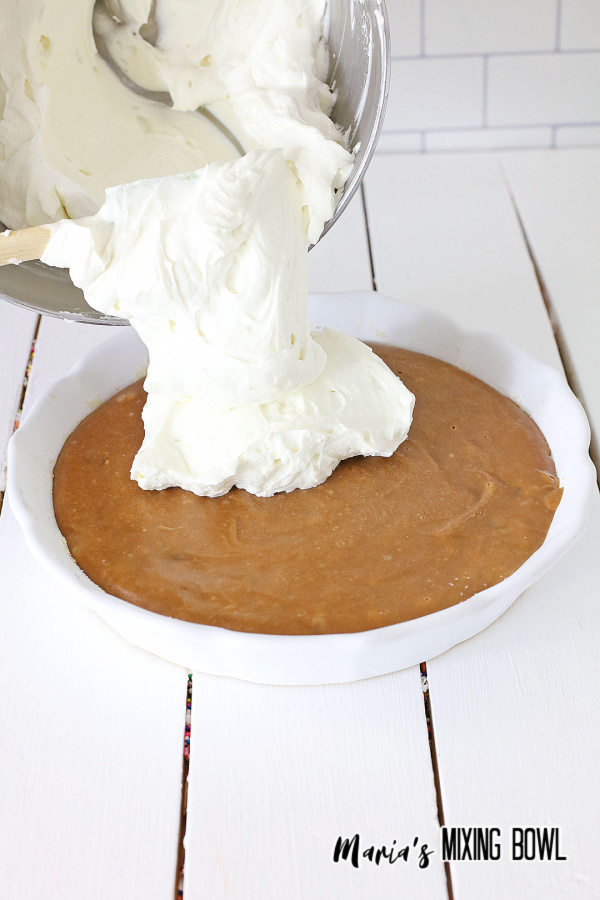 Layering whipped topping over chocolate pie base
