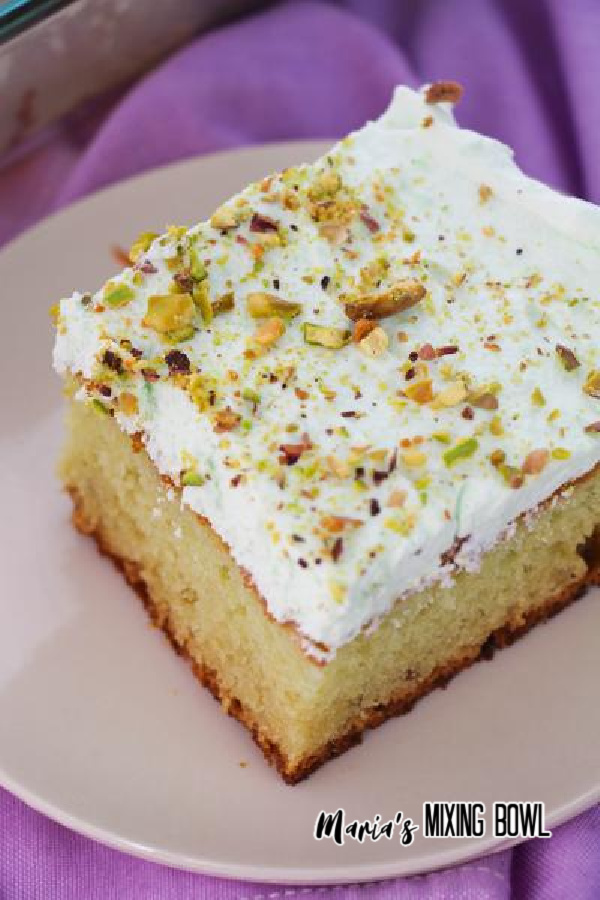 Close up of pistachio cake on white plate.