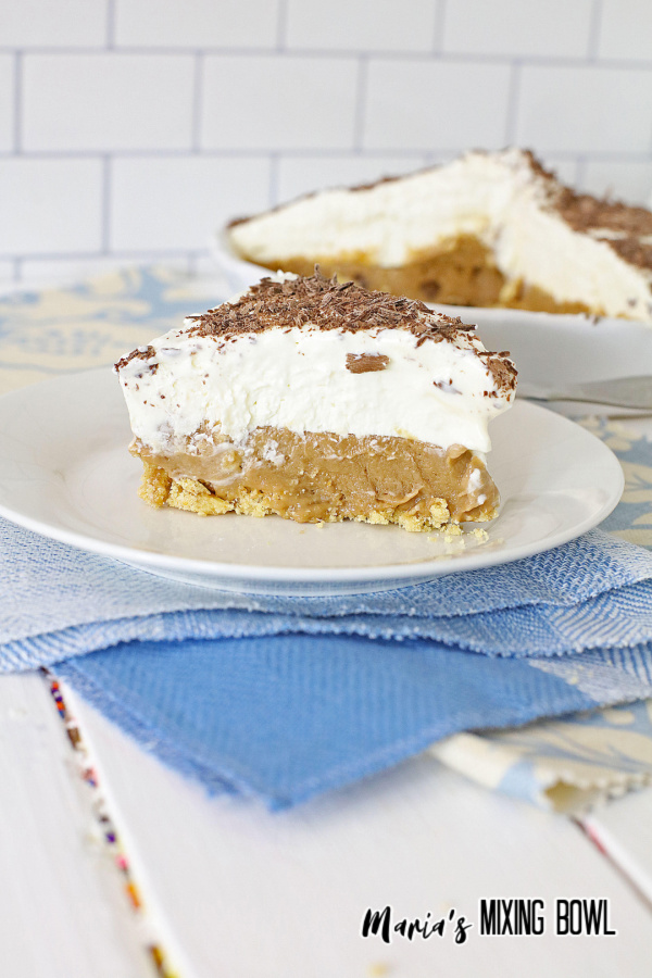dessert pie on white plate with blue and white napkin