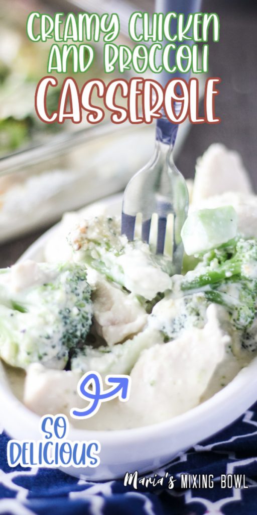 Fork stuck into creamy chicken and broccoli casserole in white dish