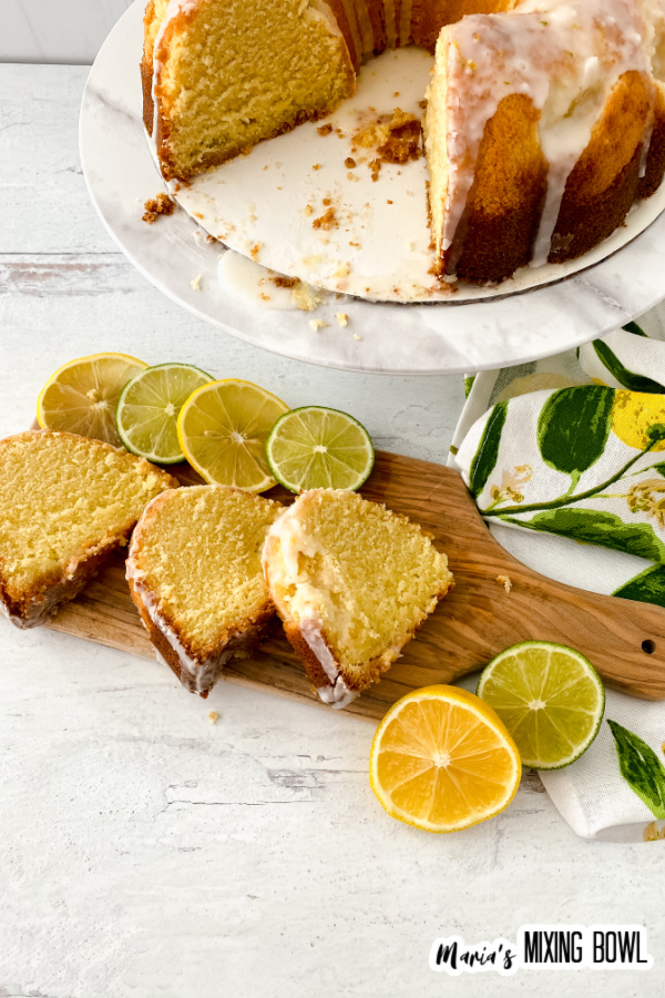 Overhead shot of lemon lime bundt cakes lices on cutting board with more cake on cake stand