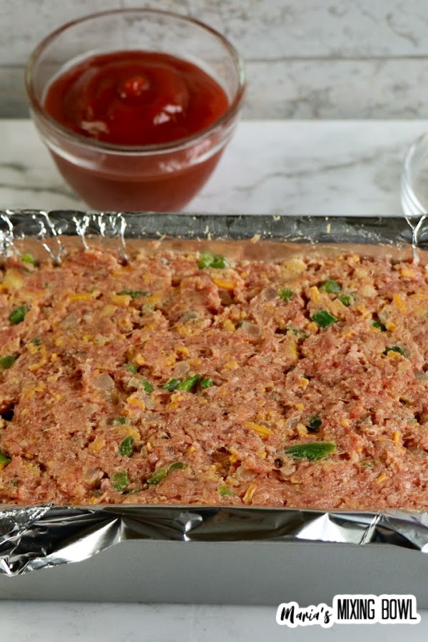 Raw meatloaf in baking dish ready to be cooked