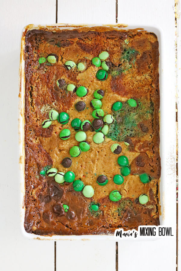 Overhead shot of cooked cake topped with M&Ms in white baking dish