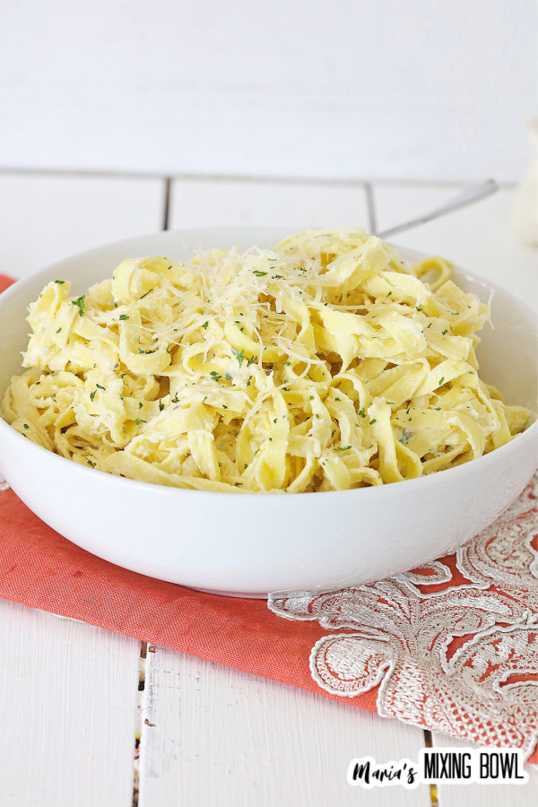 pasta in a white bowl on an orange napkin