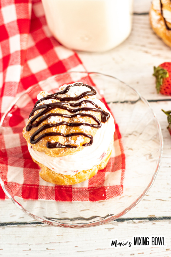 Overhead shot of strawberry cream puff on glass plate