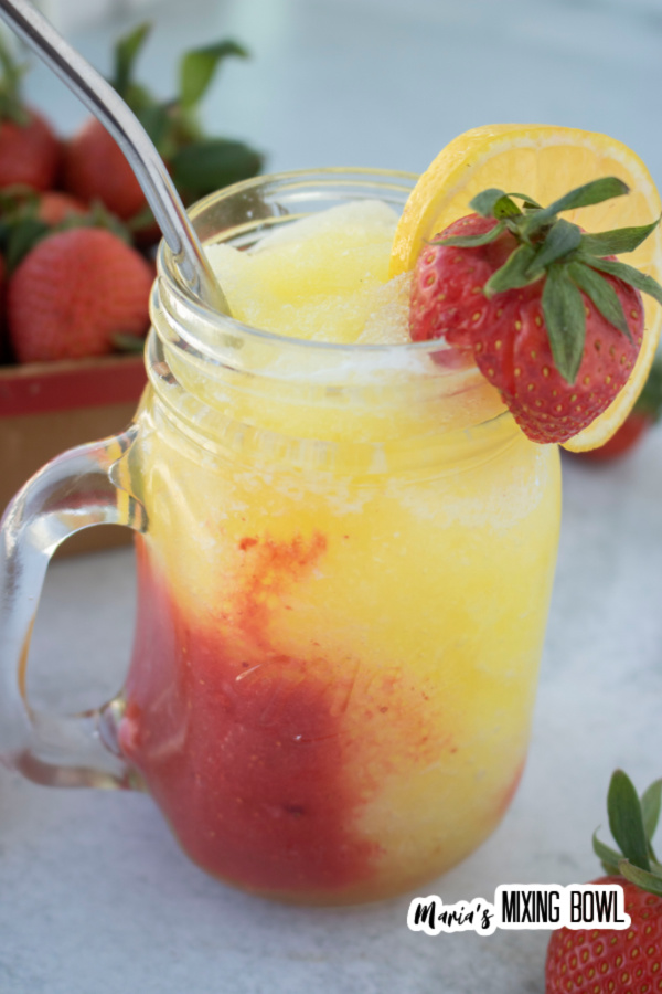 Red and yellow frozen berry lemonade in glass