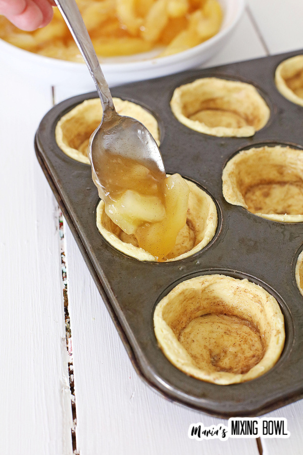 apples being put in cinnamon cups