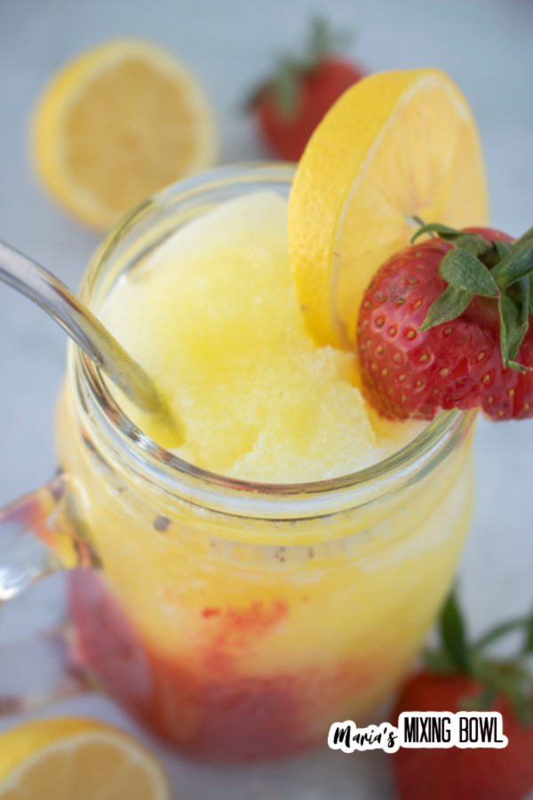 Overhead shot of frozen strawberry lemonade in mason jar glass