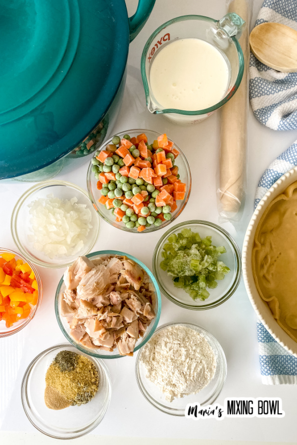 Overhead shot of ingredients for rustic chicken pot pie in individual bowls