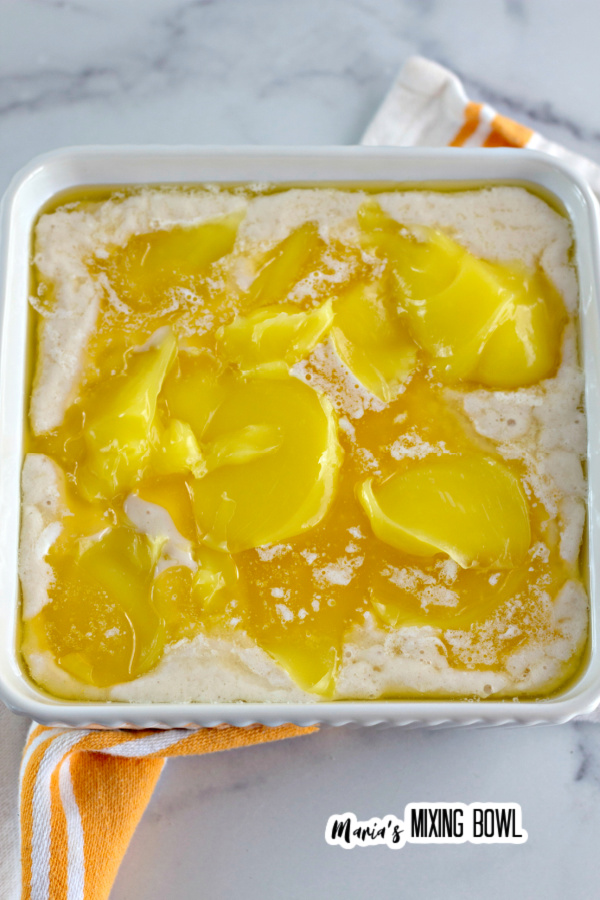Lemon filling added to mixture in white baking dish