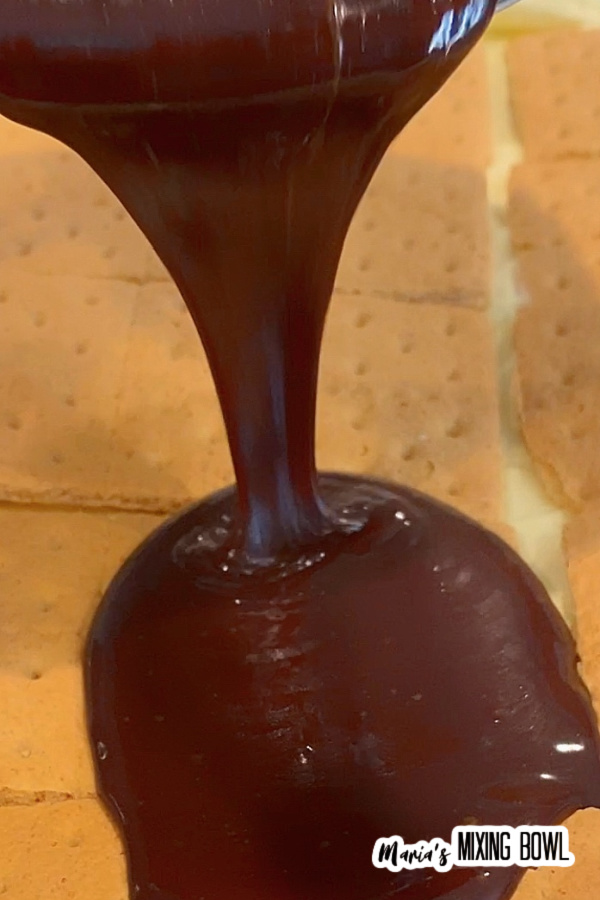 Pouring chocolage over graham crackers