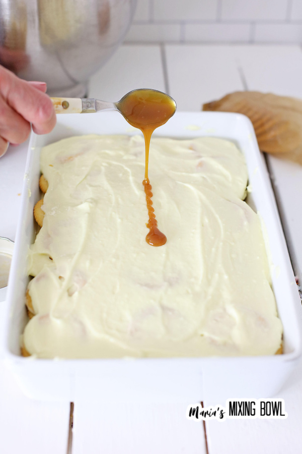 Drizzling Ritz cracker icebox cake with caramel sauce