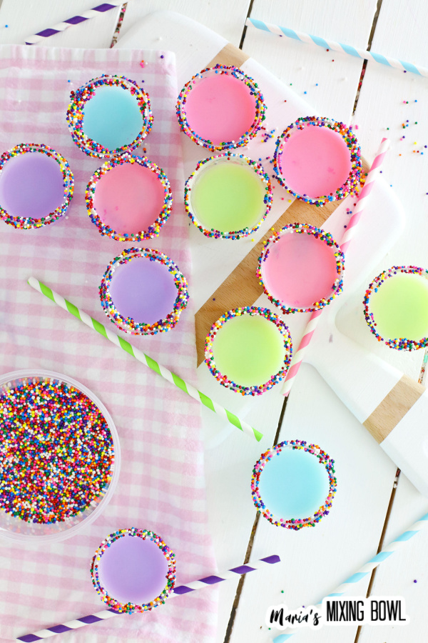 Overhead shot of colorful birthday cake shots on cutting board