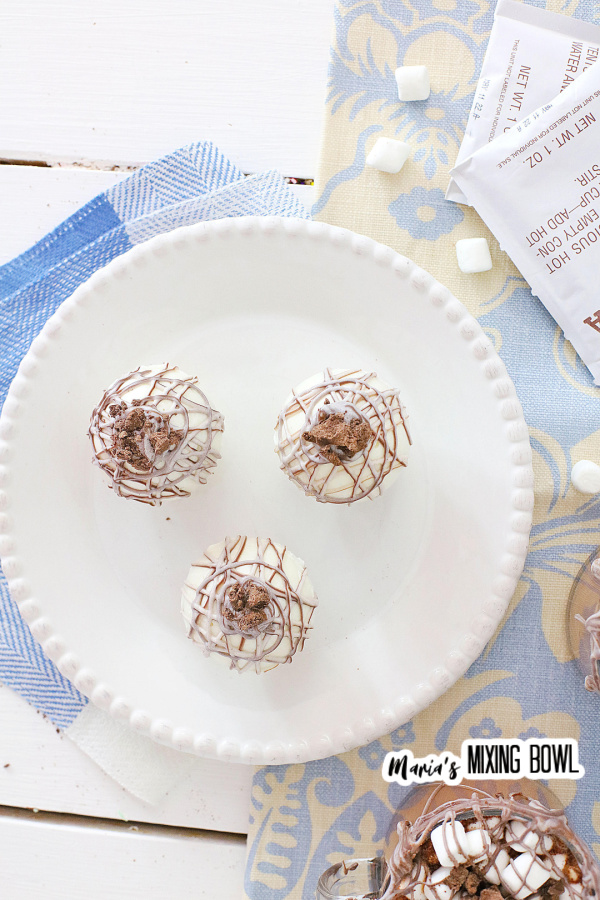 3 hot cocoa bombs on a white plate 