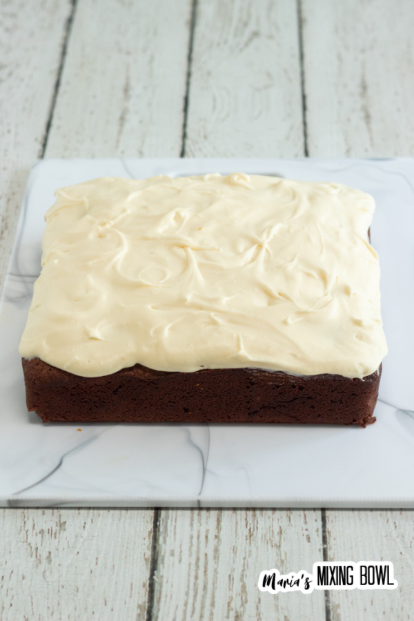 frosted brownies on a marble board
