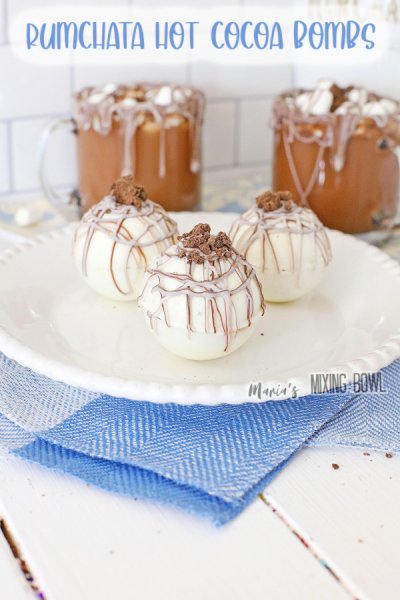 Adult rumChata hot Cocoa bombs on blue and white napkin and white plate