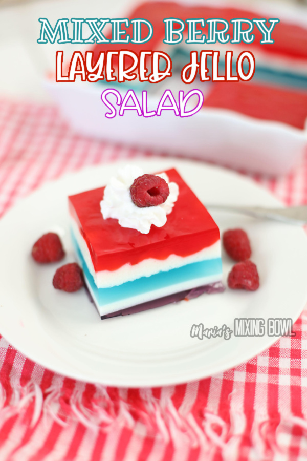 Patriotic layered jello salad with berries on white plate