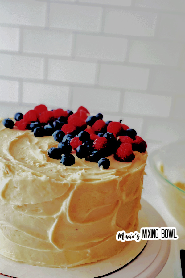 Medium shot of whole berry chantilly cake on cake stand