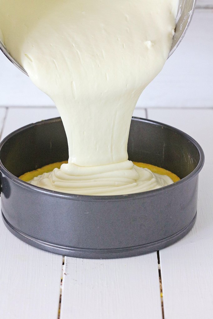 Pouring batter over base of cake in springform pan