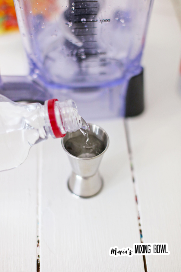 Closeup shot of vodka being poured into cocktail container