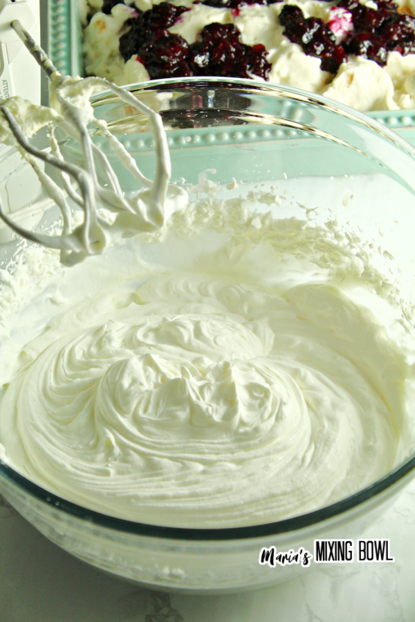 Whipped cream mixture in glass mixing bowl