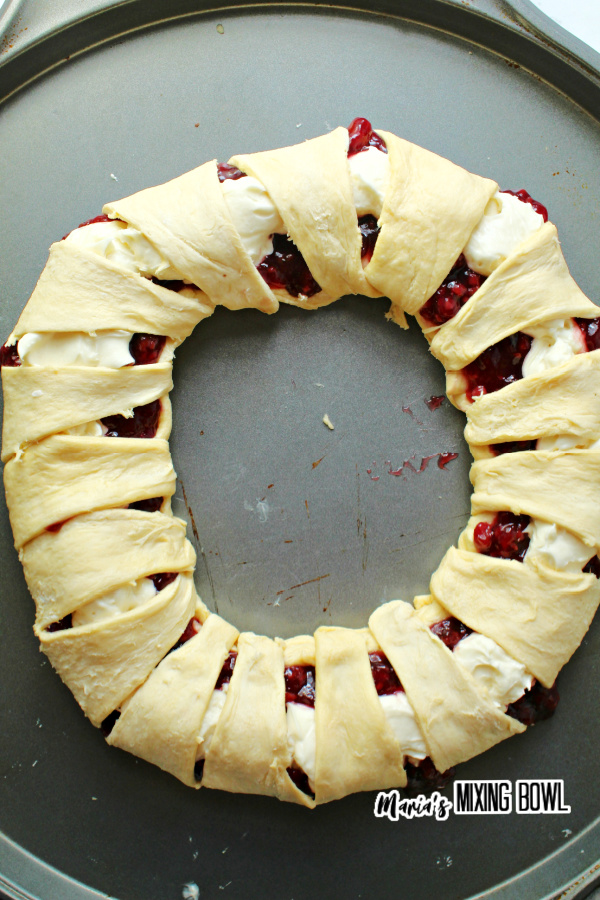 Raspberry cream cheese crescent ring rolled up and ready to bake