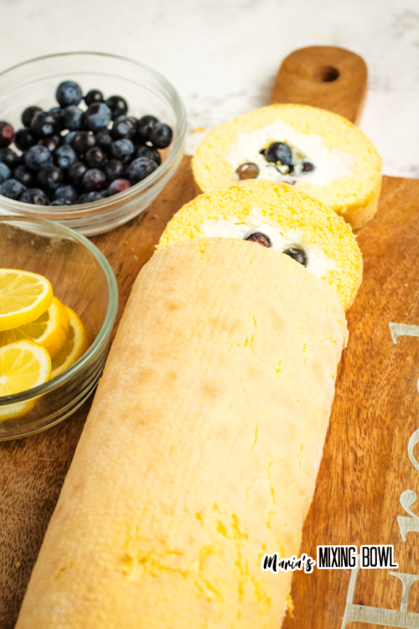 Lemon blueberry cake roll with two slices cut